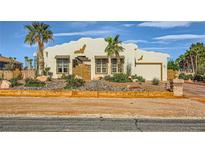 Charming single-story home featuring stucco exterior, desert landscaping, and an attached two-car garage at 440 N Lisbon St, Henderson, NV 89015
