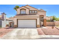 Charming two-story home featuring a tile roof, neutral stucco, and an attached two-car garage at 4514 Calico Cliff Ct, North Las Vegas, NV 89031