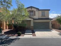Charming two-story home featuring a well-manicured front yard and a two-car garage at 6554 Macdoogle St, Las Vegas, NV 89166