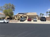 Charming single-story home featuring a tile roof, solar panels, desert landscaping, and a multi-car driveway at 6596 Secluded Ave, Las Vegas, NV 89110