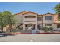 Inviting exterior view of a two-story condo building with well-maintained landscaping and easy access stairs at 8450 Alta Dr # 225, Las Vegas, NV 89145