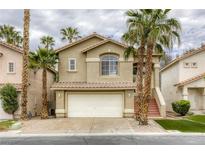 Charming two-story home featuring a two-car garage, terra cotta roof, and elegant stairwell entrance at 9966 Mystic Moss St, Las Vegas, NV 89183
