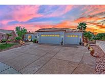 Charming single-story home boasting a tile roof, three-car garage, and mature landscaping under a colorful sunset sky at 10001 Cresent Creek Dr, Las Vegas, NV 89134