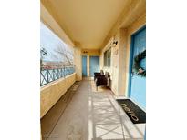 Inviting covered balcony featuring comfortable seating, offering a relaxing outdoor space with beautiful landscape view at 10553 Pine Glen Ave # 202, Las Vegas, NV 89144
