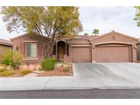 Charming single-story home with a well-manicured lawn, desert landscaping and a three-car garage at 11244 Gammila Dr, Las Vegas, NV 89141