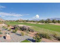 Expansive golf course view featuring lush greenery, sand traps, and mountain backdrop on a sunny day at 2024 Bay Tree Dr, Las Vegas, NV 89134