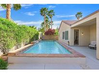 Inviting backyard pool with mature landscaping and tranquil water feature for relaxation at 2132 Twin Falls Dr, Henderson, NV 89044