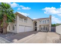 Stucco home featuring a three-car garage, balcony, red tile roof, and mature palm tree at 2595 Aviv Ct, Las Vegas, NV 89121