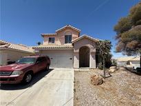 Charming two-story home with a stucco exterior, desert landscaping, and a two-car garage at 268 Dahlia St, Henderson, NV 89015