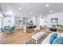 Open-concept living room and kitchen featuring modern finishes and a breakfast bar at 3104 Waterview Dr, Las Vegas, NV 89117