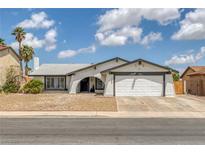 Charming single-story home featuring a two-car garage and low-maintenance desert landscaping at 325 Heather Dr, Henderson, NV 89002