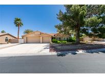 Single-story home featuring a two-car garage, palm tree, mature shade tree and manicured landscaping at 4004 Nancy Margarite Ln, Las Vegas, NV 89130