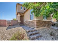 Charming two-story home with a stone-accented facade and inviting brick-paved walkway at 4902 Guysborough St, Las Vegas, NV 89148