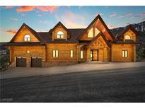 Striking log home with a multi-car garage offers curb appeal and mountain views at 4927 Snow White Rd, Las Vegas, NV 89124