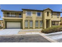Two-story home with a balcony, white trim and a two car garage at 8143 Retriever Ave, Las Vegas, NV 89147