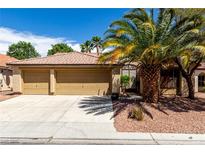 Charming single-story home with a three-car garage, beautiful desert landscaping, and a tiled roof at 9048 Faversham Ct, Las Vegas, NV 89123