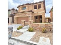 Charming two-story home featuring a stone facade, neutral stucco, and a well-maintained front yard at 10349 Mystic Pine Rd, Las Vegas, NV 89135