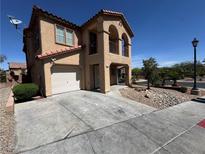 Two-story home featuring a two-car garage, red tile roof, and a small balcony at 1155 Paradise Safari Dr, Henderson, NV 89002
