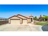 Charming single-story home features a desert-landscaped yard and a spacious three-car garage at 1204 Golf Club, Laughlin, NV 89029