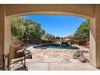 Beautiful backyard pool with rock waterfall, waterslide, and lush landscaping perfect for outdoor enjoyment at 1981 Trophy Elk Ave, Logandale, NV 89021