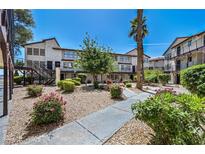 Exterior building view with landscaping, walkway, and stairs leading to units at 2080 Karen Ave # 60, Las Vegas, NV 89169
