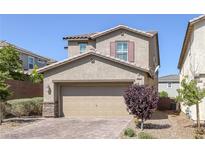 Charming two-story home with a brick driveway and well-maintained landscaping at 2827 Turnstone Ridge St, Henderson, NV 89044