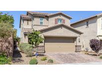 Charming two-story home with a two-car garage, desert landscaping, and a brick driveway at 2827 Turnstone Ridge St, Henderson, NV 89044