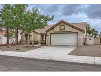 Charming single-story home with a two-car garage, desert landscaping, and a tile roof at 3104 Archwood Way, Las Vegas, NV 89134