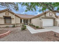 Charming single-story home with a tile roof, two car garage, and desert landscaping at 3104 Archwood Way, Las Vegas, NV 89134