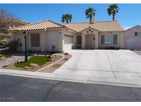 Charming single-story home with a tile roof, desert landscaping, and an attached two-car garage at 6508 Alpine Forest Ct, Las Vegas, NV 89149
