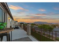 Enjoy stunning sunset views from this charming balcony with outdoor seating at 7364 Marbury St, Las Vegas, NV 89166