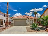 Charming single-story home featuring a two-car garage, desert landscaping, and a classic Spanish tile roof at 1012 Vanier Ct, Henderson, NV 89052