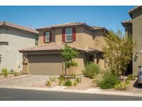 Charming two-story home featuring a two-car garage and desert landscaping in a quiet neighborhood at 10352 Rye Patch Creek St, Las Vegas, NV 89141