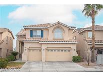 Charming two-story home with a two-car garage, lush landscaping, and inviting curb appeal at 10613 Turquoise Valley Dr, Las Vegas, NV 89144