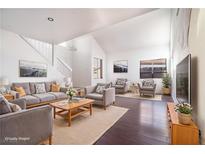 Bright living room with vaulted ceilings, hardwood floors, and neutral decor at 110 Wynntry Dr, Henderson, NV 89074