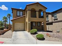 Charming two-story home featuring stucco exterior, low maintenance yard, and attached garage at 1169 Paradise River Rd, Henderson, NV 89002