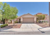 Charming single-story home featuring a well-manicured yard, desert landscaping, and a two-car garage at 1212 Anime Dr, Las Vegas, NV 89144