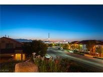 An elevated street view displays a glimpse of the city skyline against a colorful dusk backdrop at 2434 Amoretti St, Henderson, NV 89052
