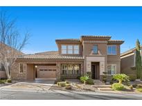 Beautiful two-story home featuring a covered entrance, stone accents, manicured landscaping, and an attached two-car garage at 2717 Mona Lisa St, Henderson, NV 89044