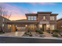 Elegant two-story home boasting a tile roof, desert landscaping, and an attached two-car garage at 2717 Mona Lisa St, Henderson, NV 89044