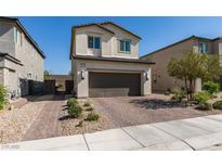 Inviting two-story home featuring a brick driveway and a convenient two-car garage at 2928 Sunday Silence Rd, North Las Vegas, NV 89086