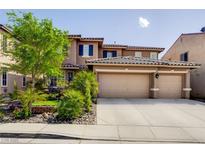 Two-story home with a three car garage, desert landscaping, and a beautiful tiled roof at 4017 Kristina Lynn Ave, North Las Vegas, NV 89081