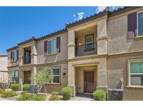Charming townhouse with private balconies, manicured landscaping, and a welcoming entryway at 489 Filaree Pl, Henderson, NV 89015