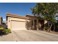 Charming single-story home with a two-car garage, desert landscaping, and a welcoming entryway at 6623 Brick House Ave, Las Vegas, NV 89122
