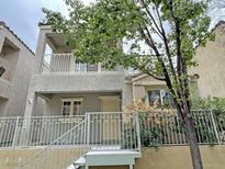 Charming two-story home featuring a cozy balcony and well-maintained landscaping at 7412 Bewitching Ct, Las Vegas, NV 89149
