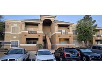 Two-story condo building with well-maintained landscaping and ample parking spaces at 8070 W Russell Rd # 1105, Las Vegas, NV 89113