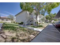 Inviting two-story condo featuring manicured landscaping, sidewalks, and easy access stairs at 8804 River Pines Ct # 202, Las Vegas, NV 89117