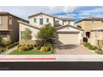Charming two-story home with a two-car garage, lush landscaping, and a welcoming front yard at 16 Cresta Villa Ct, Henderson, NV 89011