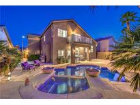 Inviting backyard with pool, spa, lounge area, and patio is perfect for outdoor entertaining at 2248 Verde Cape Ave, Henderson, NV 89052