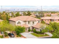 Two-story home boasts a red tile roof, manicured landscaping, and a view of the Las Vegas skyline at 366 Rancho La Costa St, Las Vegas, NV 89138